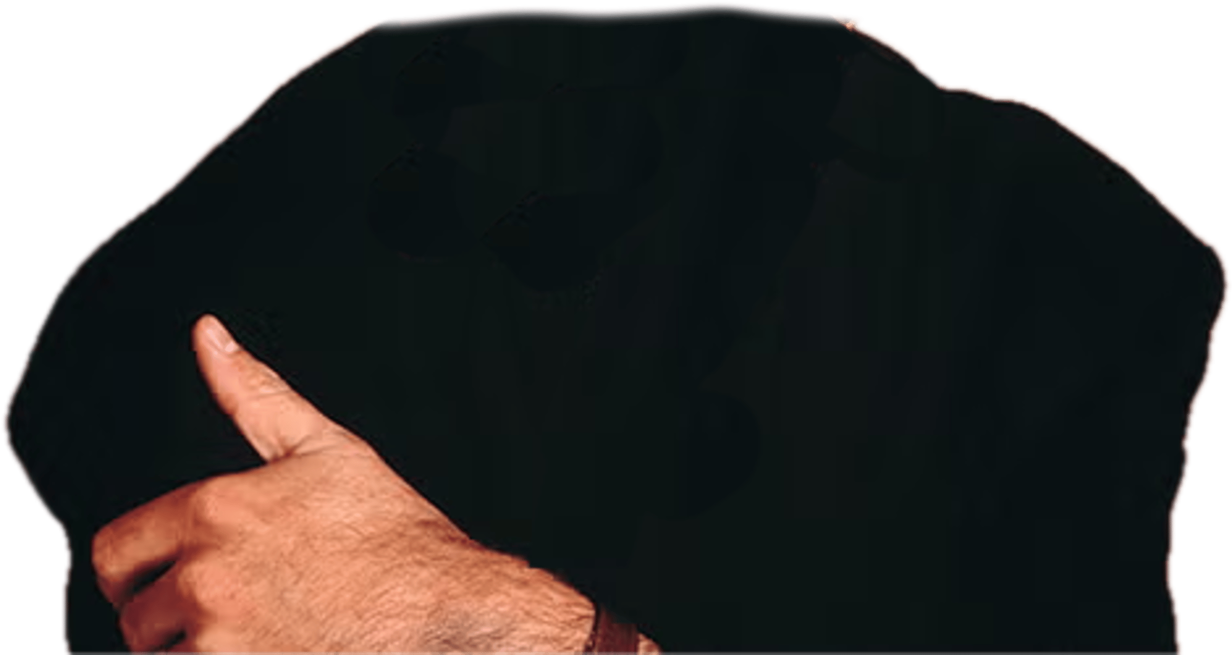 The top part of George Michael's body, wearing a black suit, with his arms folded.